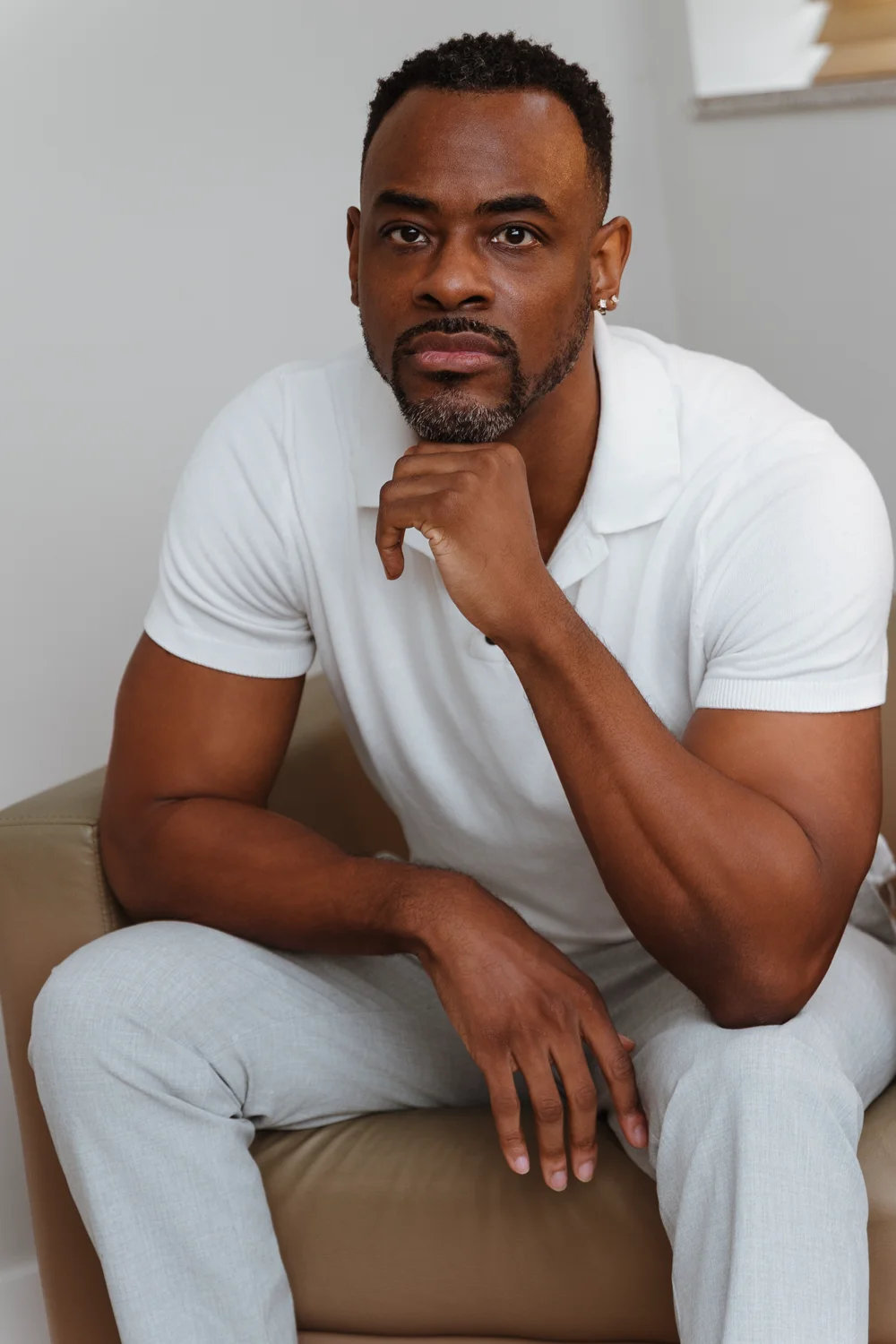 Lamin Ngobeh seated in a white polo shirt